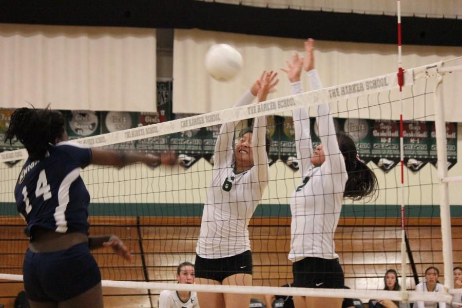 Jacqueline Chen (12) and Lindsey Trinh (11) block a hit from the opposing side. The varsity girls volleyball lost to Menlo today.
