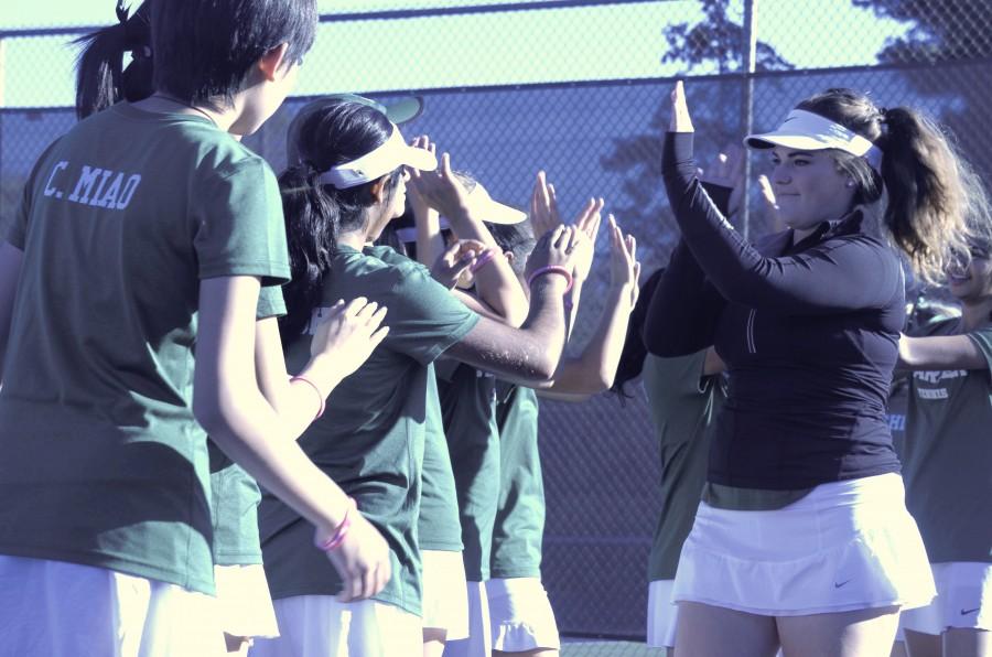 Senior and co-captain Izzy Gross (12) high-fives her teammates’ hands as they celebrate her senior night. The team played Menlo today on their senior night. The final score was 3-4.