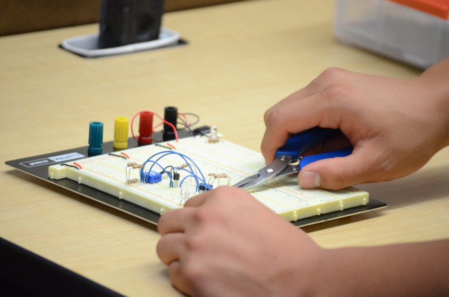 Alex Wang (10) wires up a breadboard in his computer architecture class. Ahmeds plight has resonated with many similar makers around the world.