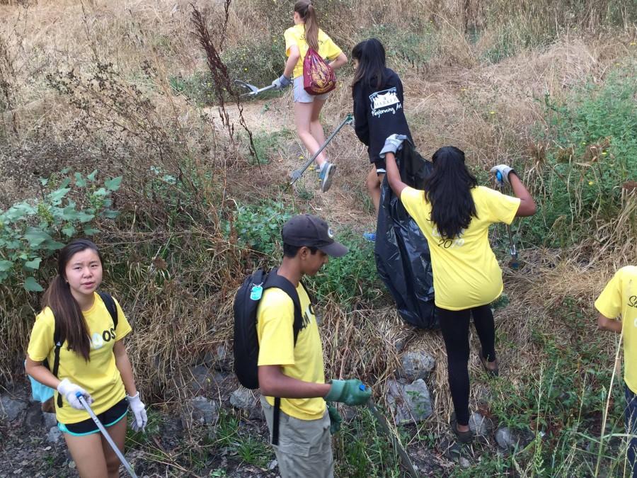 Freshmen walk up the side of a hill searching for trash at the Guadalupe River Park Conservancy. The entire class went on a community service trip to Guadalupe River Conservancy while the sophomores and juniors took the PSAT on Wednesday. 