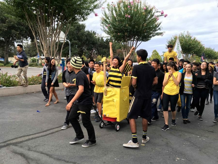 The sophomores walk in the parade with their bee hive themed float. The parade was held yesterday in the quad. 