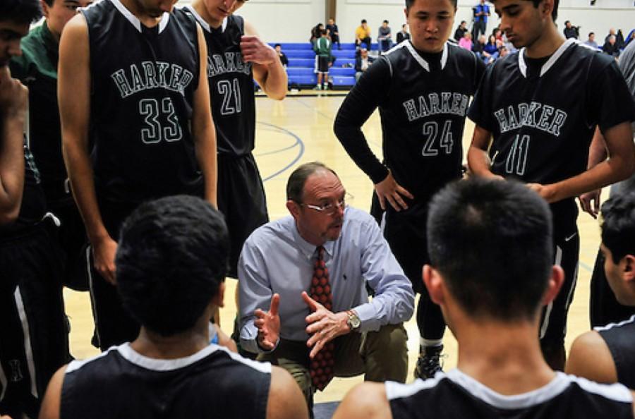 Keller prepares the Varsity boys basketball team for the next quarter of a game in January of 2015. Keller is also the head coach of the team.