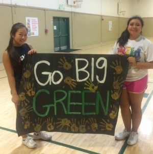 During practice, Alisa Wakita (12) and close friend and teammate Marita Delalto (12) hold up a sign made by the cheerleaders themselves for the football players. Making signs before the games is a cheerleading tradition.