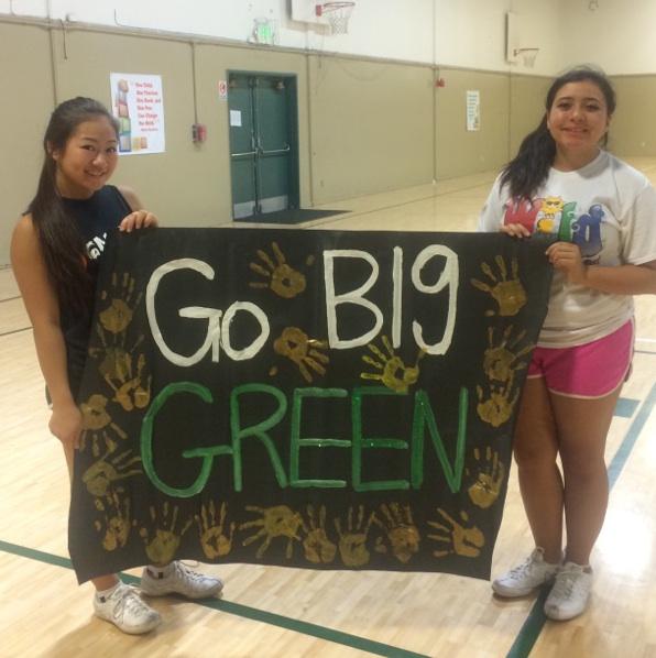 During practice, Alisa Wakita (12) and close friend and teammate Marita Delalto (12) hold up a sign made by the cheerleaders themselves for the football players. Making signs before the games is a cheerleading tradition.