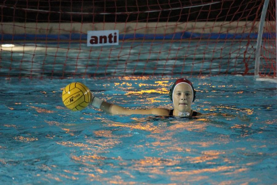 Senior Helena Dworak prepares to throw the ball during the varsity girls water polo game. The Eagles lost the match 1-10.