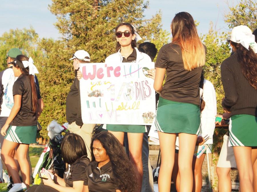 Vanessa Tyagi (10) holds up a sign celebrating the girls golf teams seniors. The team had their senior night game on Monday against Mercy High School Burlingame.