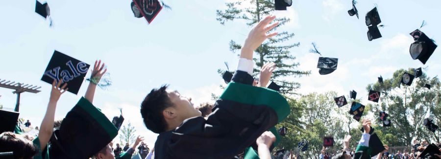 Mathew Ho (15) celebrates graduation as he throws his cap into the air. Preparing for college is a major step for most seniors, but the College Scorecard system fails to address the accuracy of the application process.
