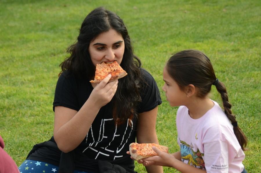 Zahra Budhwani (11) and her Eagle Buddy enjoy pizza together in pajamas during their last Eagle buddy meeting during the last academic year. The juniors reunited with their Eagle buddies for the first time this year yesterday. 