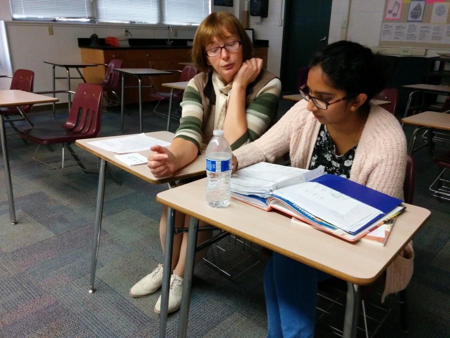 Galina Tchourilova gives advice to Jessica Susai for French class during extra help. Teachers, parents and students have the opportunity to talk about the students academics during Parent-Teacher conferences.