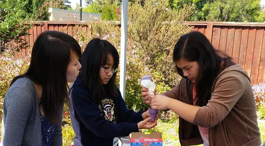 Three Foothill High School students perform an experiment at a Science for Youth club meeting. Sci- ence for Youth club’s mission is to encourage and instruct children in various scientific fields.
