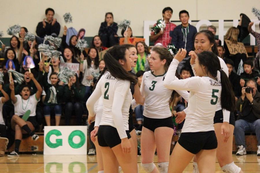Varsity teammates cheer after they win the point. The team defeated Mercy Burlingame on their senior night game.