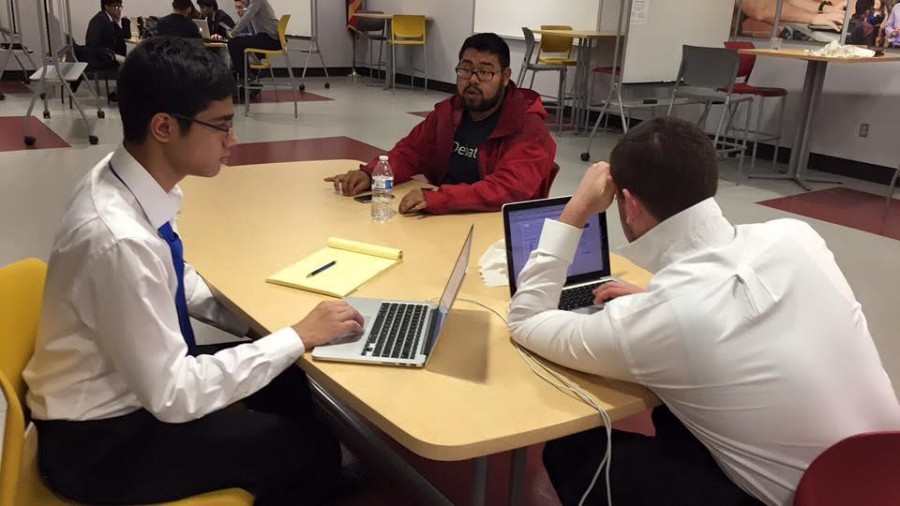 Rishab Gargeya (11) and Misha Tseitlin (11) prepare for their next Congress round with their coach. Rishab was a semifinalist and Misha was a finalist, both competing in a field of 139 Congressional debaters.