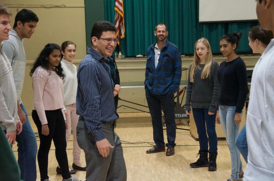 Abel Olivas laughs after two students show their dance routine to the group. Students were able to add their own moves to the dance during the lesson.
