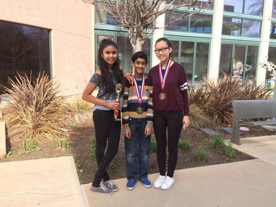 Divya Rajasekharan (11), Nikhil Dharmaraj (9) and Lisa Liu (12) pose with their trophies outside Dobbins. All of them competed at the Martin Luther King Jr. Invitational last weekend.
