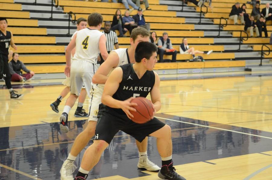Junior Jordan Goheen moves around with the ball during offense in a game against Menlo. They lost the game 49 to 66. 