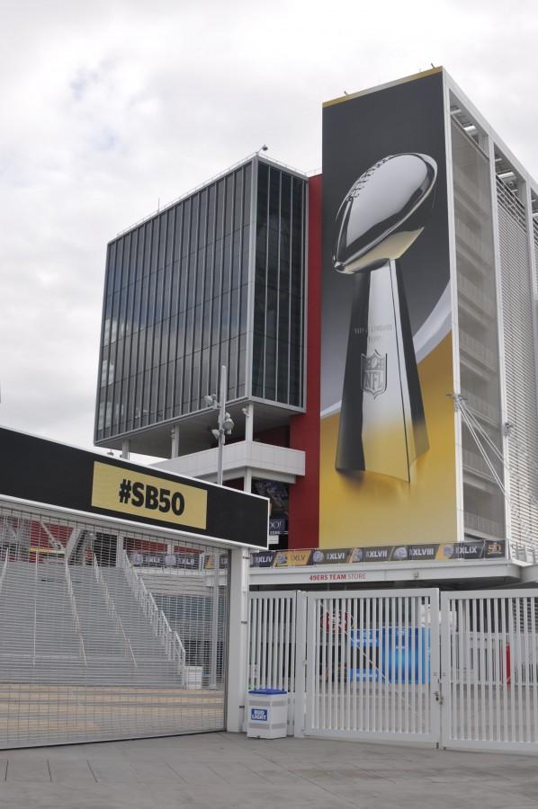 The Lombardi Trophy is pictured on a poster that has been draped on the side of Levis Stadium. The winner of Super Bowl 50 receives this trophy.