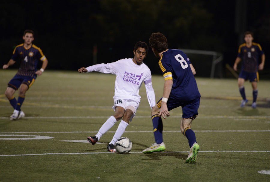 Sparse Chauhan (10) tries to get around a Knights player. He scored the only goal of the night in the first half of the varsity boys game.