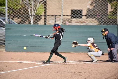 Freshman Anika Rajamani swings the ball at an incoming ball. The team scored 21 runs and held Gunderson High to 2 runs.