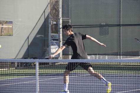 Neil Bai performs a backhand close to the net during his match against King's Academy. The boys won 6-1. 