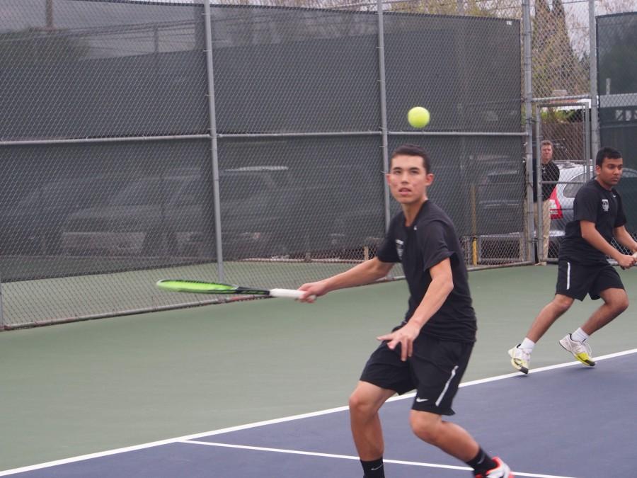 A Harker tennis player prepares to hit the ball during the team's match yesterday. They won 5-2.