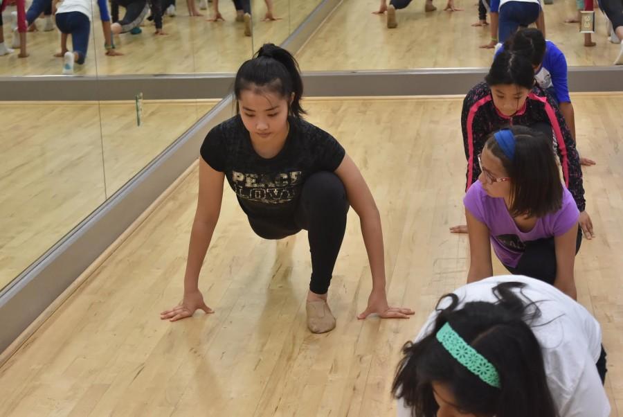 Liana+Wang+%2810%29+leads+members+of+a+fifth-grade+dance+class+in+warming+up+during+a+March+14+dance+class+at+the+Lower+School.+Karl+Kuehn%2C+upper+school+dance+program+director%2C+conceptualized+the+idea+for+the+program+with+Gail+Palmer%2C+dance+program+director+for+the+Lower+and+Middle+Schools.