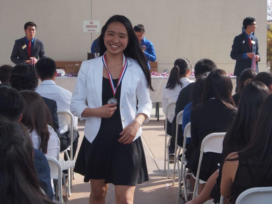 Sophia Luo (12) smiles as she returns to her seat after receiving her first-place medal in Career Preparation. Sophia founded Harker TSA in her sophomore year.