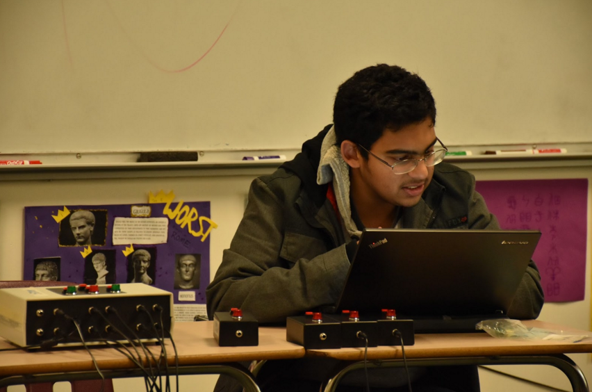 Nikhil Manglik (11) reads practice Quiz Bowl questions from his laptop during their practice. The Quiz Bowl team practices every Wednesday in Andrea Milius’s room, and their next tournament is March 5.