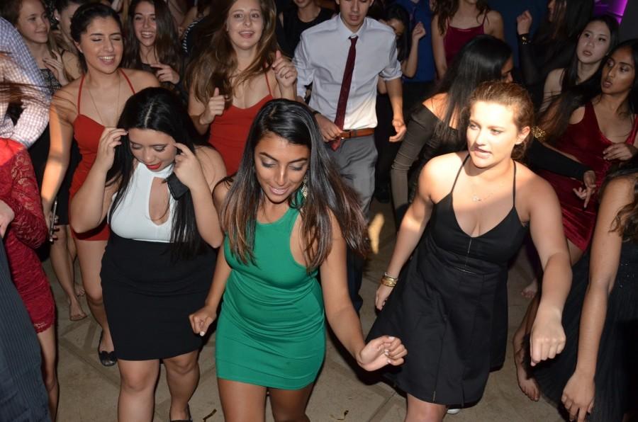 Namitha Vellian (12), Emma Doherty (12) and Marita DelAlto (12) dance with the crowd. Winter Ball was on Feb. 20. 