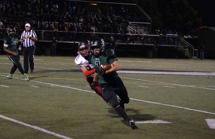 Sophomore Anthony Contreras runs with the football during the homecoming game in the fall.