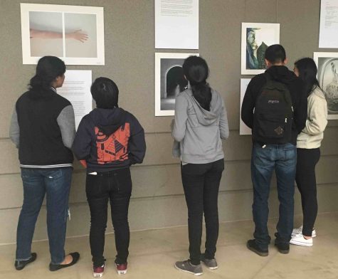 Students look at art and writing on display at the Artstravaganza today during long lunch. The event included a performance by jazz band, the unveiling of this year's issue of HELM magazine and readings by selected authors.