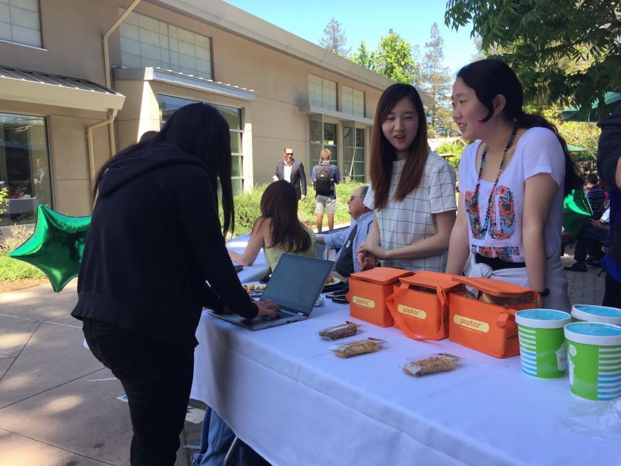 Interact Co-President Kevina Xiao (12) sells Popbar and Pinkberry during Wednesday long lunch. The club has sold Pinkberry during all four annual club weeks that it has hosted.
