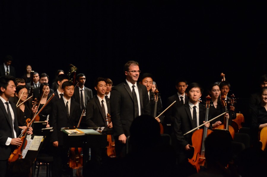 The+upper+school+orchestra+members+stand+up+after+their+performance.+The+annual+Spring+Concert+was+held+yesterday+at+7+p.m.