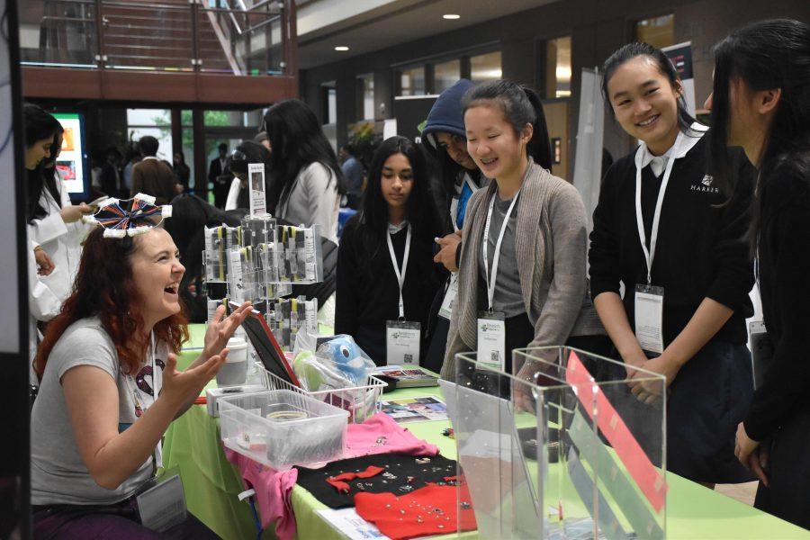 Middle school students talk to a representative at a booth at the annual Harker Research Symposium. The 11th research symposium was held on April 9.