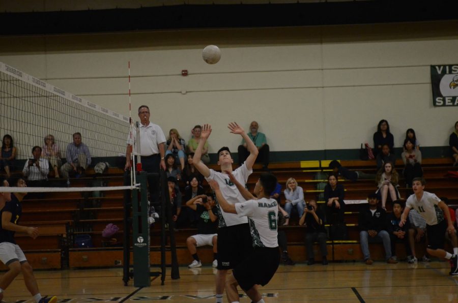 Charlie Molin (9) sets up for Ray Song (11) to hit to ball over the net. The boys won 3-0