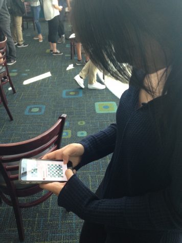 Kelsey Wu (9) prepares to make a move during a game of Facebook Chess. Facebook Messenger users can use a command to start a game of chess with a friend..jpg