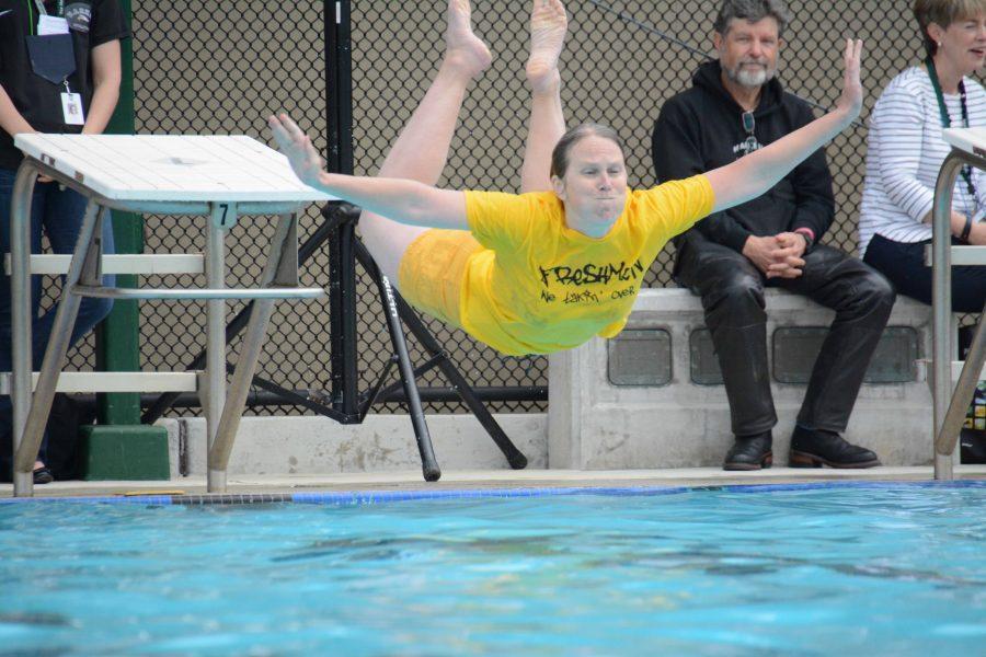 Physics teacher Dr. Miriam Allersma belly-flops into the pool after the regatta. The four classes competed in the annual regatta competition on April 21. 