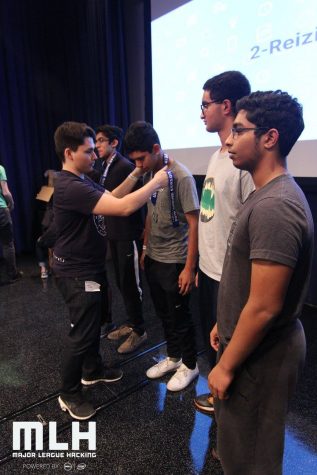 Kedar Gupta (11) receives an award for his participation at a Hackathon. Some Harker students interested in developing software attend Hackathons across the Bay Area. 