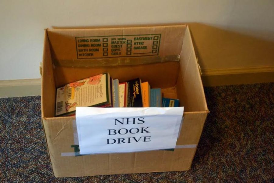 Students donate old AP books in the nHS book drive box from a few years ago. NHS began hosting a book drive this week.