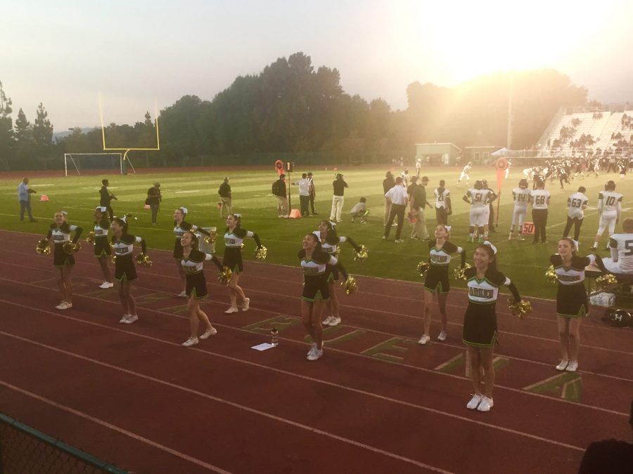 Harker cheerleaders deliver a cheer early in the first quarter. The Eagles won against the Warriors 21-14.