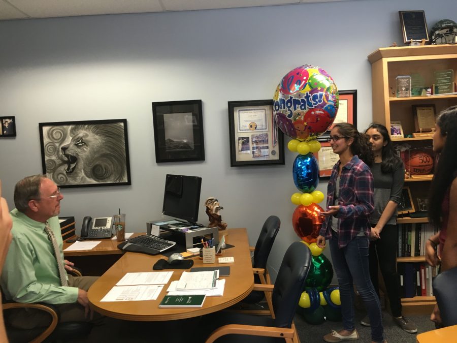 Harker Aquila Editor-in-Chief Raveena Kapatkar and Winged Post Managing Editor Sahana Srinivasan congratulate Upper School Head Butch Keller with balloons. Keller won the award for Administrator of the Year today. 