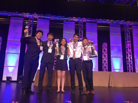 Juniors Michael Kwan, Jerry Chen, Sahana Srinivasan, Shaya Zarkesh and Randy Zhao pose on stage after receiving their first place trophies on June 30. The team placed third in presentation and problem solving and fourth in the essay. 
