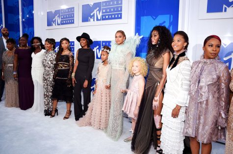 Beyoncé stands at the front of the building where the VMAs were held in Manhattan, with females featured in the music video of her new influential album "Lemonade." 