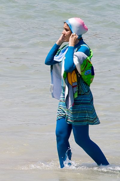 A woman wears a burkini on the beach. Passionate debates concerning the legality and morality of the ban continue in France.