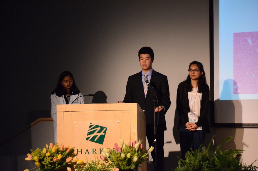 Regional finalists David Zhu (12) and Evani Radiya-Dixit (12) present their Siemens project at last year's research symposium  as moderator Richa Bhattacharya (11) looks on. David and Evani were two of 97 regional finalists last year. 