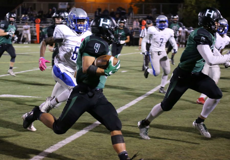 Will Park (12) avoids a tackle while running down the field. Harker lost 49-12 to the Encinal Jets.