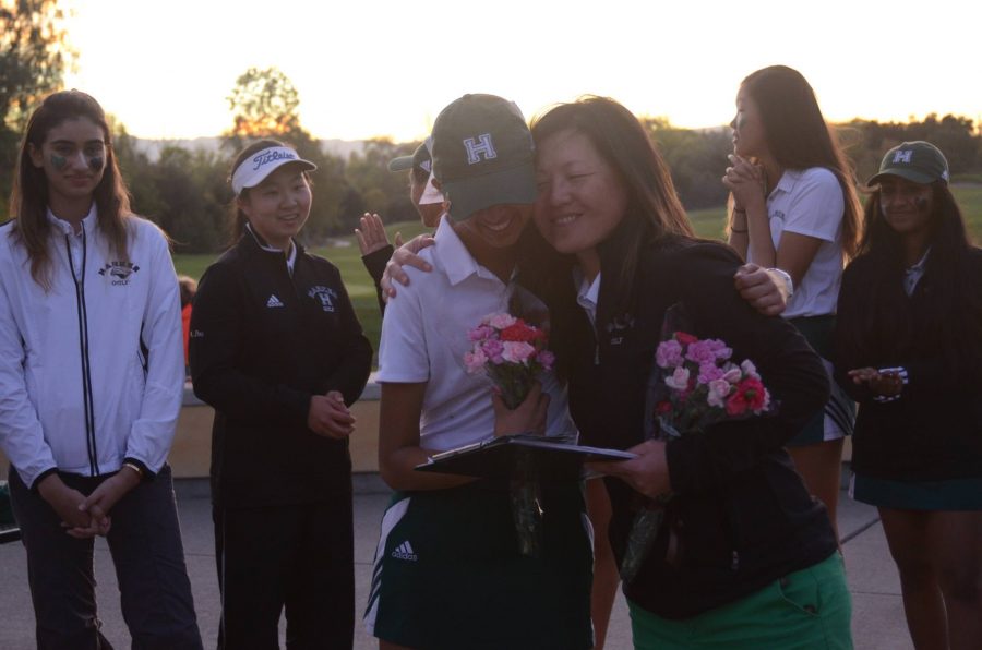 Coach Ie-Cheng hugs Alexis Gauba (12) in the ceremony after the game. The girls honored their captains on their senior night in a 199-201 loss against the Castileja School. 