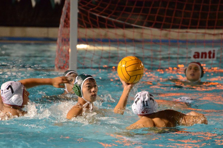 Peter Wu (12) retrieves the ball on defense and looks to pass down the pool. The varsity boys won against Fremont 16-6.