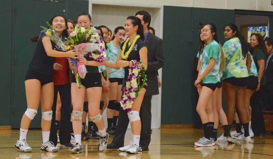 Melissa Kwan (11) and Katrina Liou (10) honor senior Rachel Cheng with flowers on senior night. The Eagles won 3-1 against Notre Dame at Blackford on Thursday.
