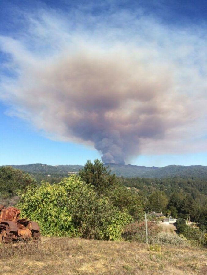 A plume of smoke rises from the Santa Cruz Mountains on Sept. 26. The Loma Fire, which started in the Santa Cruz Mountains that day, has since blazed through 4,474 acres and destroyed 28 structures in its path.
