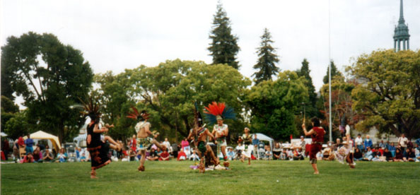 Tribal members deliver one of the dances of the ceremony at the first Indigenous Peoples Day celebration and pow-wow in Berkeley in 1993. The dances performed included the men's Fancy Dance, consisting of intricate footwork, and the Jingle Dance, a healing dance in which dancers perform dressed in row upon row of chiming cones. ​